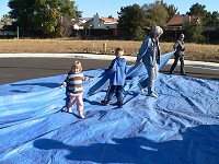 Both kids helping to pack the tarp Both kids helping to pack the tarp