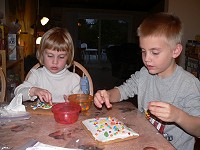 Kids building a gingerbread house