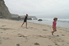 Kids frolicking on a beach.