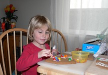 Lisa decorating Christmas gingerbread house Lisa decorating Christmas gingerbread house