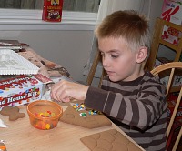 Tom decorating Christmas gingerbread house Tom decorating Christmas gingerbread house