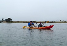 Tom paddling on a kayak.