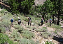 Expedition scrambling uphill. Expedition scrambling uphill.