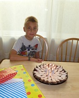 Tom's got eight candles on his cake.