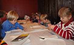A recipe for behaved children at a restaurant? Wear them out first, then make them busy.
