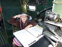 Lisa in the C-47 Skytrain navigator seat Lisa in the C-47 Skytrain navigator seat.