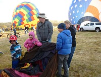 Kids helping with a balloon envelope. Kids helping with a balloon envelope.