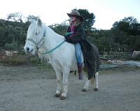 The pony does not mind the slicker as long as Lisa is wearing it. The pony does not mind the slicker as long as Lisa is wearing it.