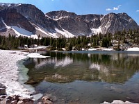 Mirror Lake — in mid-June, snow dominates at ten thousand feet. Mirror Lake — in mid-June, snow dominates at ten thousand feet.