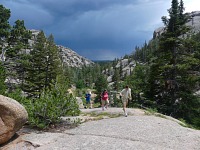Visitors in Box Canyon during a storm. Visitors in Box Canyon during a storm.