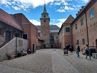 Akershus: a fortress with a tower and a courtyard.